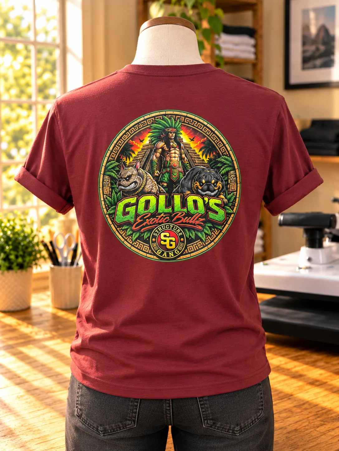 Back view of a maroon Gollo’s tee with a large colorful back print.