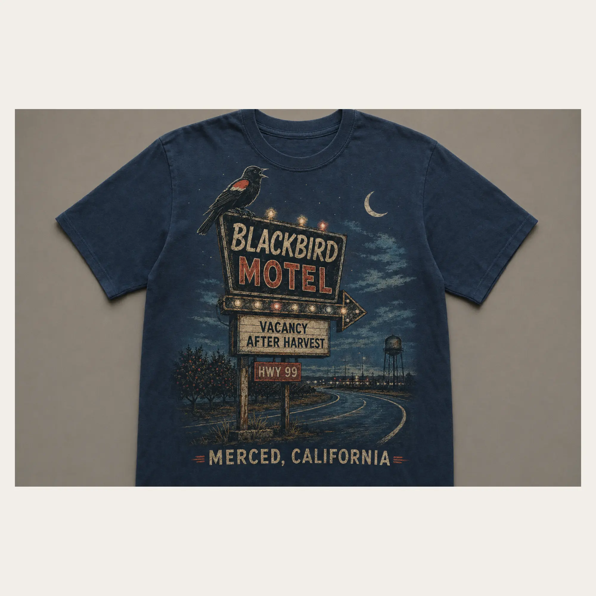Midnight navy Blackbird Motel Merced graphic T-shirt with a vintage roadside motel sign and crescent moon