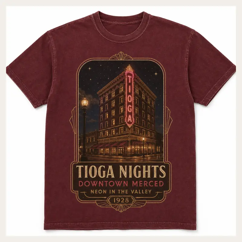 Washed burgundy Tioga Nights graphic T-shirt with a vintage downtown Merced building and neon sign