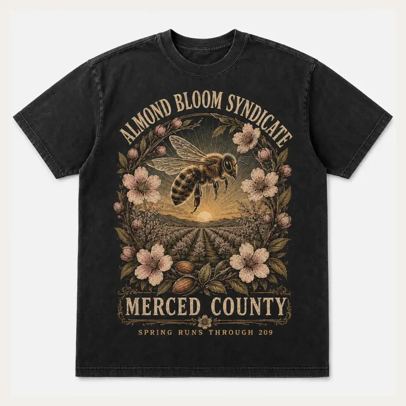 Washed black Almond Bloom Syndicate Merced County graphic T-shirt with almond blossoms and orchard rows