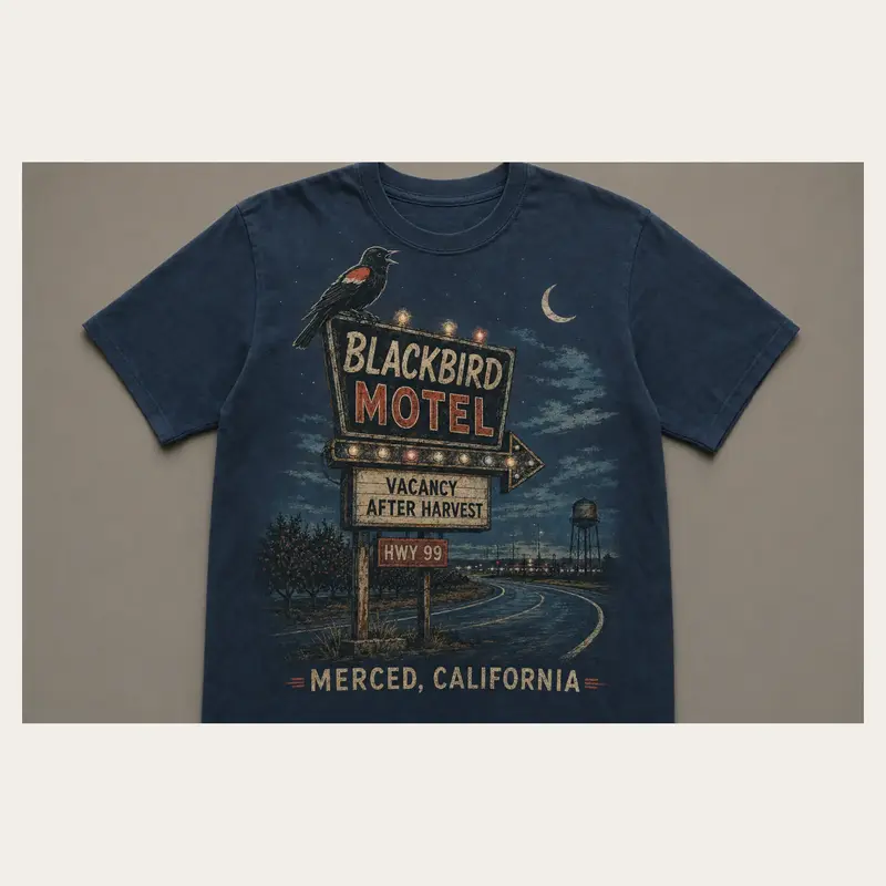 Midnight navy Blackbird Motel Merced graphic T-shirt with a vintage roadside motel sign and crescent moon