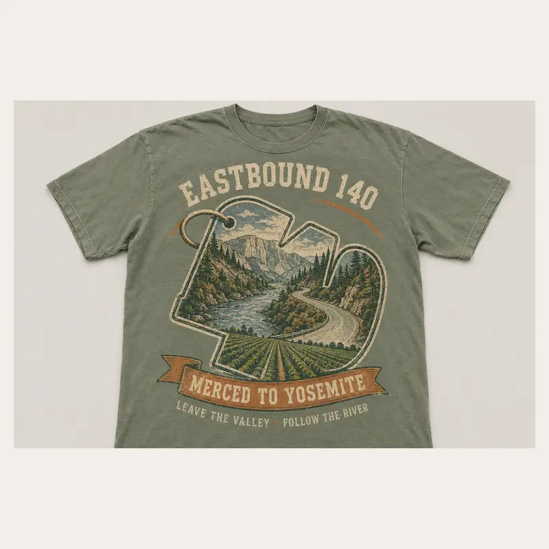 Sage green Eastbound 140 graphic T-shirt with a vintage winding road from Merced toward Yosemite